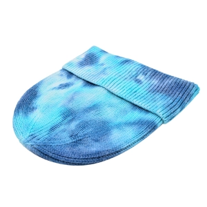 Trendy blue tie-dye knitted beanie with ribbed texture for winter sports and outdoor wear.