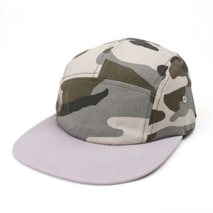 Detail of 5-panel camo camper hat featuring metallic side eyelets and flat grey brim