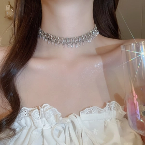 Detailed view of silver choker featuring sparkling pavé diamonds and teardrop pendants