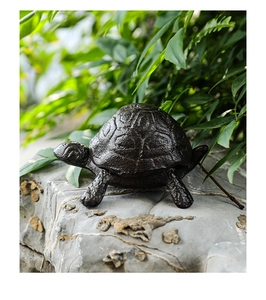 Detailed texture of cast iron turtle shell storage box on a natural grey rock background