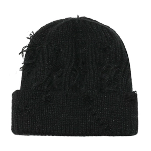 Detailed view of black distressed knit beanie with ripped holes and ribbed texture