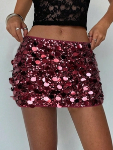 Macro detail of wine red sequin mini skirt with glossy texture and elegant finish