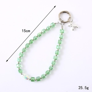 Green crystal beaded phone strap with silver dog charm and iridescent bead, 15cm length