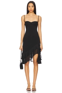 Detail of slim-fit black camisole dress featuring asymmetric ruffled hem and mesh inserts