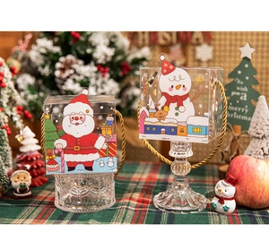 Detailed view of Christmas apple gift boxes with Santa and Snowman cartoon designs