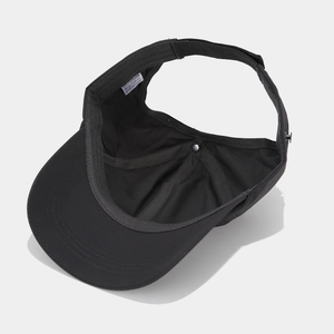 Detail view of black polyester sun visor showing adjustable strap and interior stitching