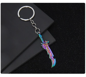 Detailed macro shot of a rainbow-colored metal sword keychain with intricate fantasy blade