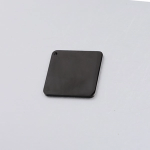 Detailed macro view of a 30mm square mirror-finish titanium steel tag with pre-drilled hole
