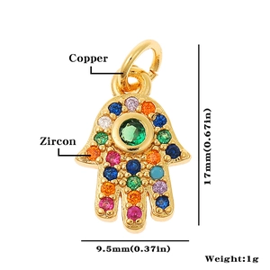 Macro view of gold-plated Hamsa pendant with zircon stones and dimensions 17x9.5mm