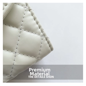 Macro shot of white leather texture and classic diamond quilted stitching details