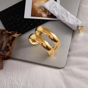 Minimalist 18K gold stainless steel double-layered open cuff bracelet on a desk