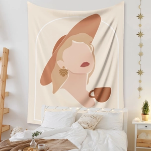 Detail showing the abstract female portrait tapestry hanging in a cozy bedroom
