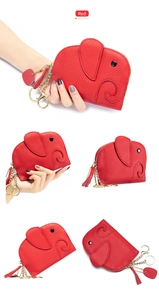 Detail view of red elephant coin purse with lychee grain leather and tassel keychain