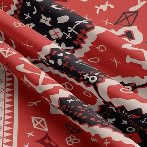 Macro detail of Bohemian tapestry showing twill fabric texture and red geometric prints