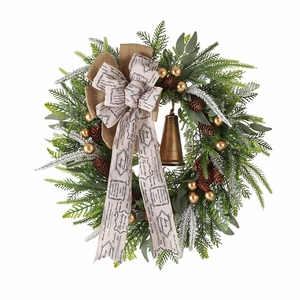 Rustic Christmas wreath with pine cones, golden berries, and a vintage metal bell on white