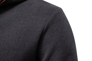 Close-up of high-quality dark gray knitted fleece hoodie with brown leather detail
