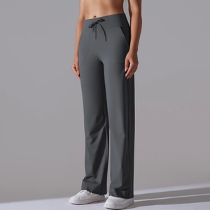 Close-up of wide waistband with drawstring and functional pockets on grey yoga pants