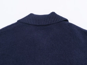 Detail of navy blue short sleeve knit sweater showing the ribbed neckline and soft texture