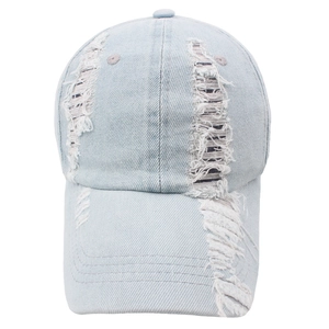 Distressed light blue washed denim baseball cap with ripped details and frayed edges