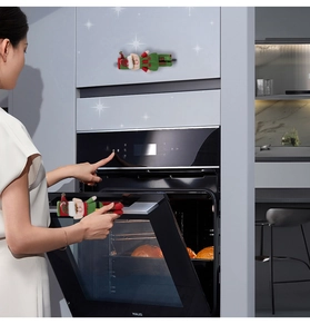 Detailed view of red and green Christmas elf covers on oven door appliance handles