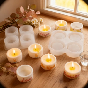 Detailed view of 4-cavity silicone mold with finished candles featuring embossed words