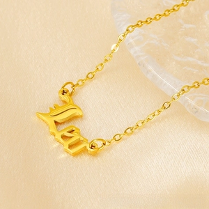 Detailed close-up of 18K gold Leo zodiac pendant on a fine link chain over satin