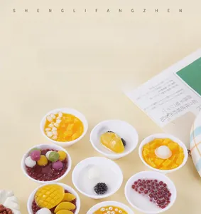 Detailed macro view of 5cm miniature resin dessert bowls with mango and taro ball textures