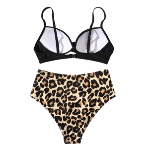 Detailed view of high waisted leopard bikini bottom and black top with metal buckle