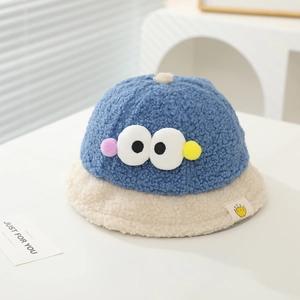 Detailed close-up of soft blue sherpa bucket hat with cute 3D cartoon eyes for kids