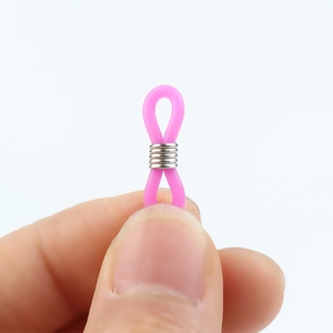 Macro shot of pink silicone eyeglass chain connector with metal spring loop component