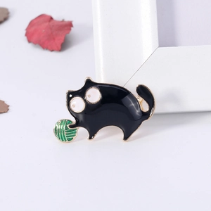 Cartoon black cat enamel brooch with green yarn ball and gold-plated alloy finish