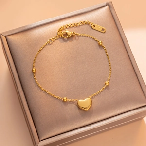 Elegant 18KGP gold heart bracelet with beads on a luxury brown velvet jewelry box
