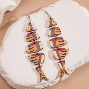 Detailed view of articulated fish bone earrings with orange wood print and silver hooks