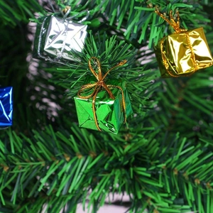 Colorful laser foam Christmas tree gift box ornaments with gold strings on pine tree