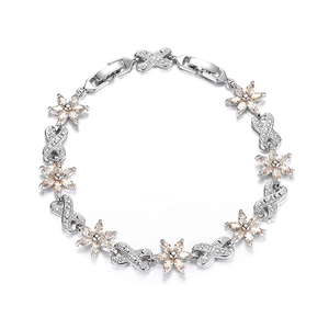 Detail showing champagne zircon flower and infinity link patterns on a silver bracelet