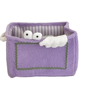Purple monster plush storage basket with cute eye detail and striped lining for toy storage