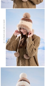 Detailed knit texture and faux fur trim on winter ear flap hat with fluffy pom-poms