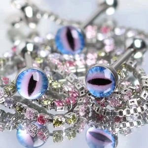 Macro shot of stainless steel snake eye tongue rings with vibrant resin stone details