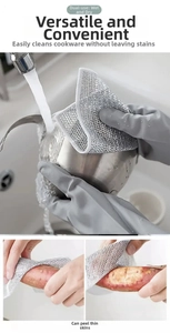 Detail of silver wire dishcloth scrubbing stainless steel pot and peeling sweet potato