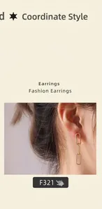 Close-up of elegant 18K gold plated titanium triple oval link chain drop earrings