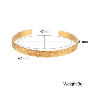 Detailed view of golden twisted cable bangle showing 6.1mm width and 61mm inner diameter