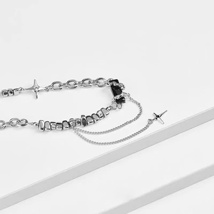 Detailed view of multilayer titanium steel chain with black gemstone and star pendant
