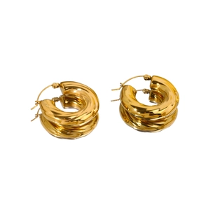 Polished 18k gold plated hollow hoop earrings with twisted texture on reflective surface