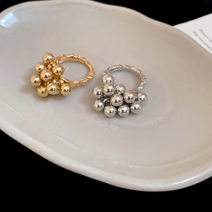 Detail of gold and silver open rings with irregular hammered bands and metal beads