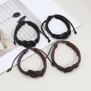Set of four woven leather bracelets in black and brown with adjustable handmade knots
