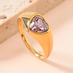 Close-up of gold titanium steel ring with large heart-shaped purple gemstone
