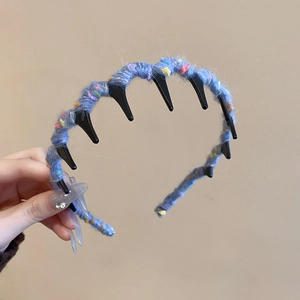 Detail of blue knitted wool headband featuring colorful speckles and anti-slip inner teeth