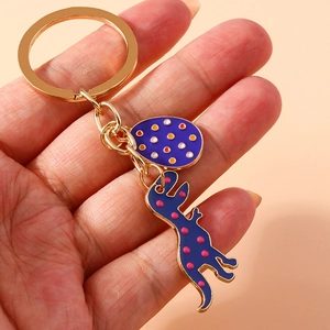 Cute blue dinosaur and egg keychain charm with colorful dots on gold metal ring