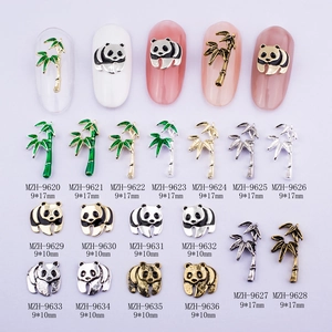 Detailed view of panda and bamboo alloy nail art charms in gold and silver finishes