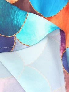 Detailed close-up of colorful chain print fabric with refined stitching for long maxi dress